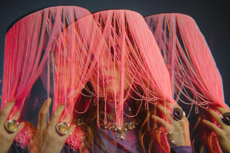 an image of woman with pink hair covered in beading