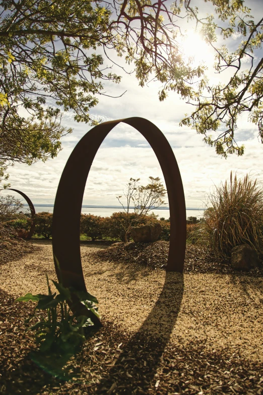 a metal structure sitting in the middle of a grassy field