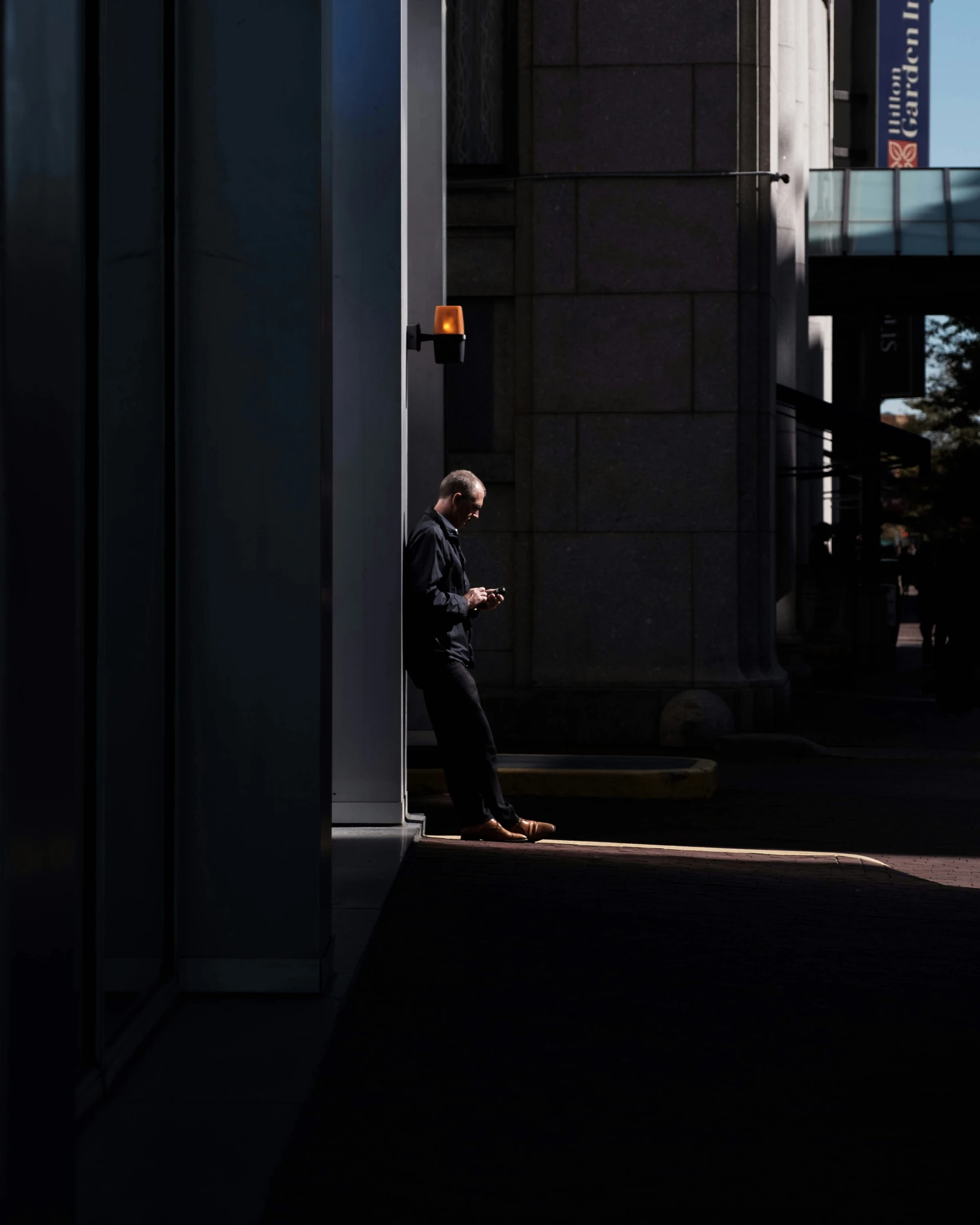 a man that is sitting down using a phone