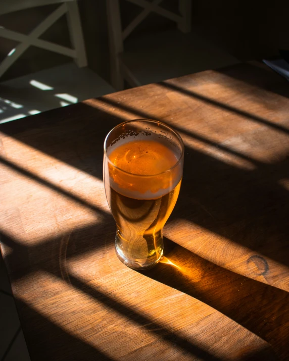 a light shines in a glass on the table