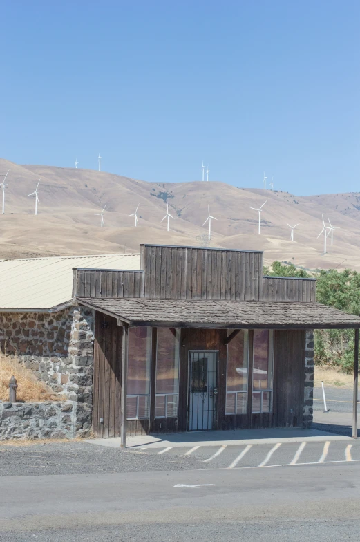 an old building with several wind mills in the background