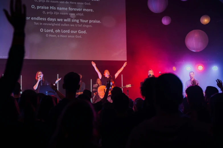 a po of people watching a man perform in front of an audience