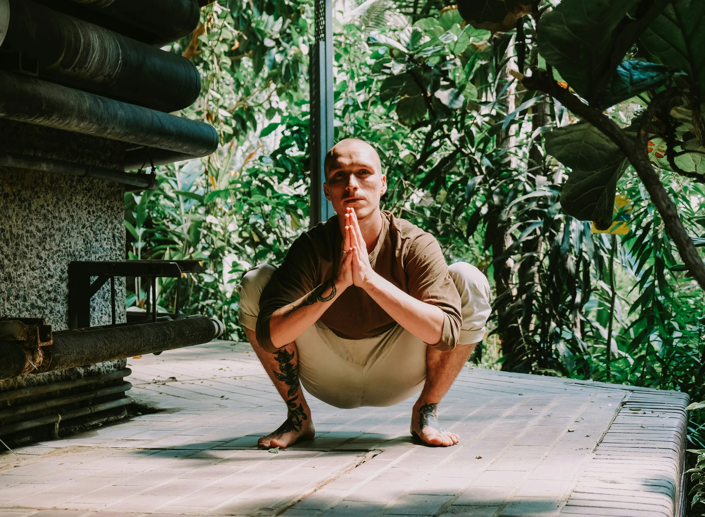 a man with his hands together and eyes closed doing yoga