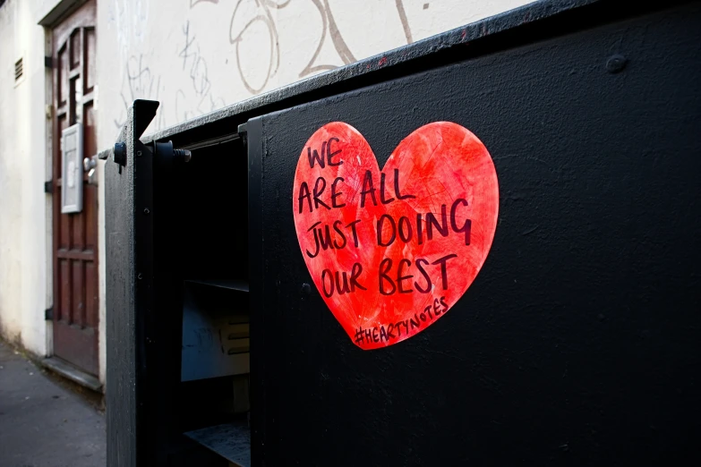 a heart on the side of a building with words on it