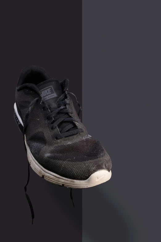 a sneaker that has been taken off with a heel