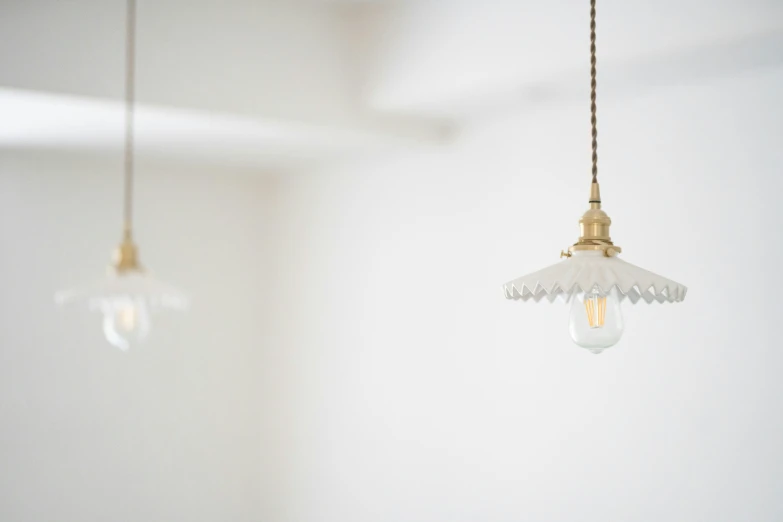 three glass light bulbs hanging from a ceiling