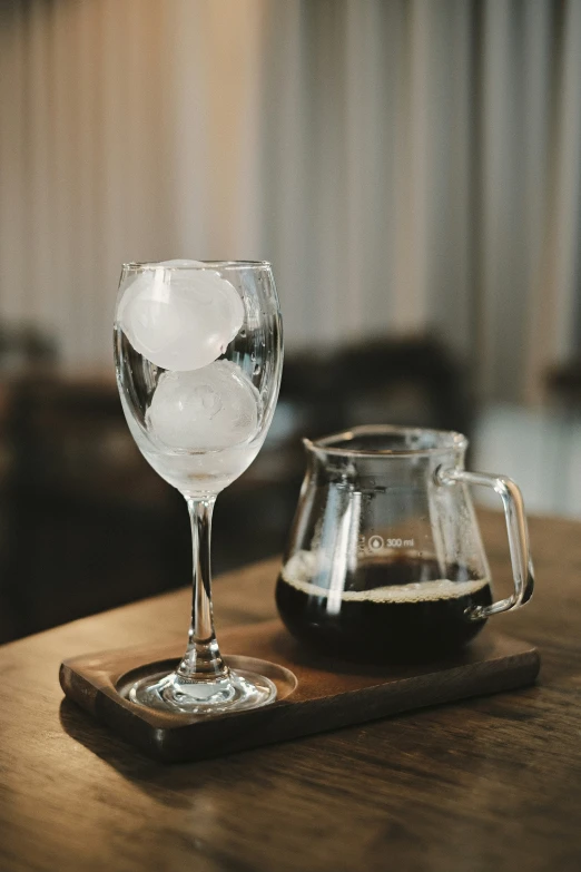 a couple of wine glasses sitting on top of a wooden table