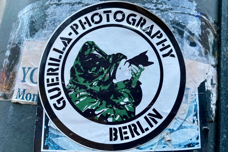 a sticker depicting a man holding a camera