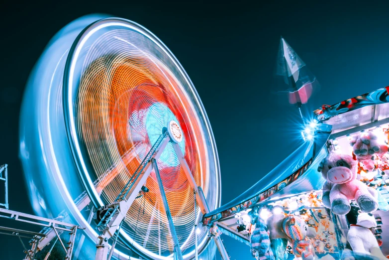 a colorful ferris wheel is glowing at night