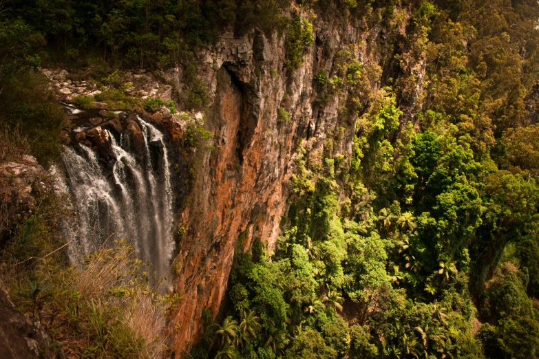 a large body of water flowing out of a cliff into the air