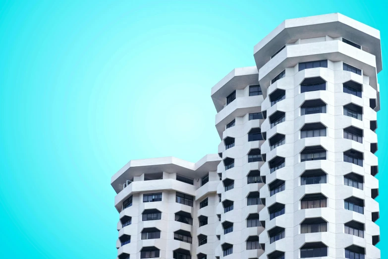 two tall buildings are shown against the blue sky