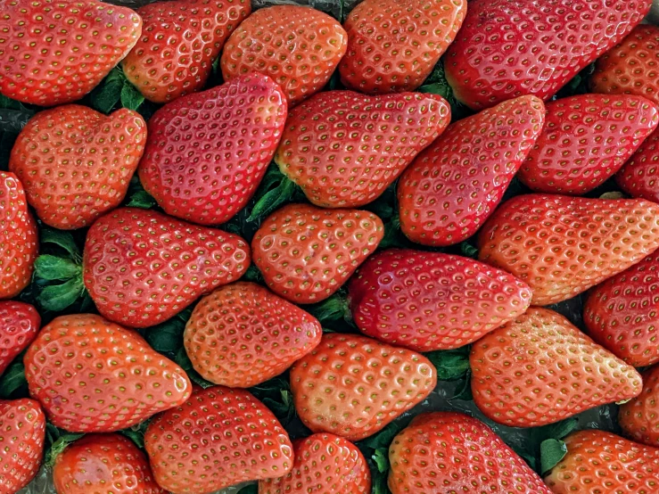 a pile of fresh strawberries sitting together