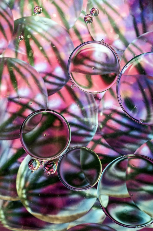 several bubbles floating over water on a table