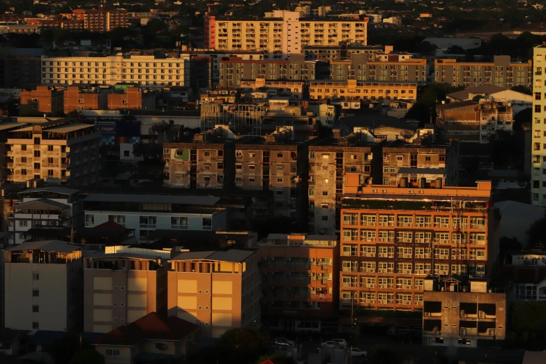 many high rise buildings sit at sunset in a city