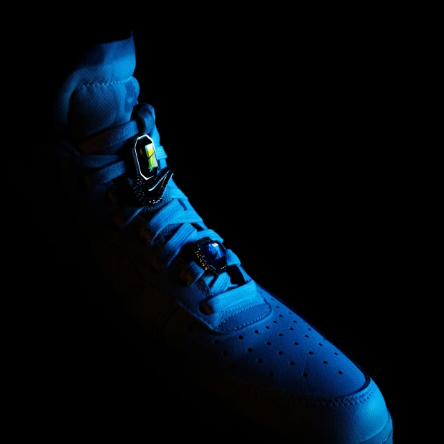 a pair of sneakers lit up by some blue light