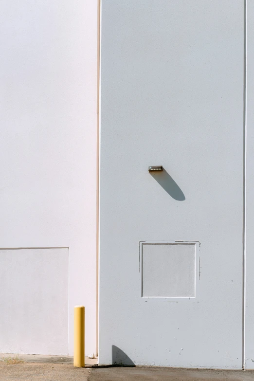 a parking meter is sitting in front of a tall door