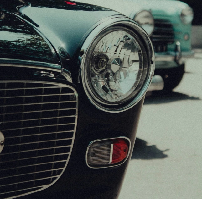 two old fashioned cars are parked in a lot