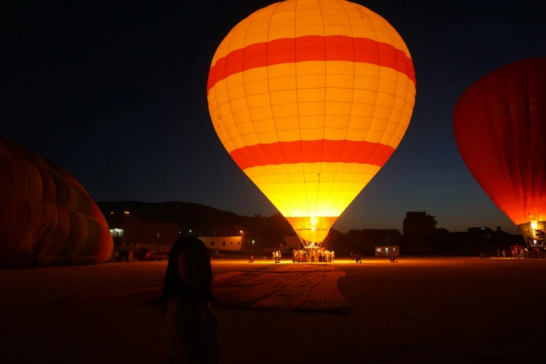 three  air balloons lit up at night