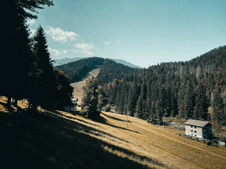 a road with a shack at the bottom