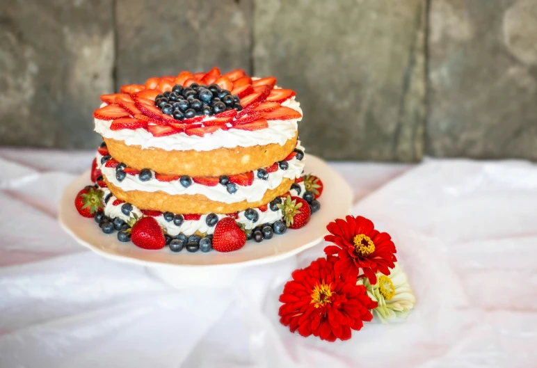 the cake has berries and blueberries on it