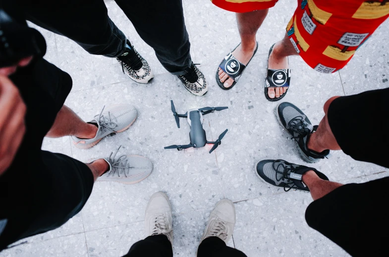 a group of people stand in a circle with their shoes on