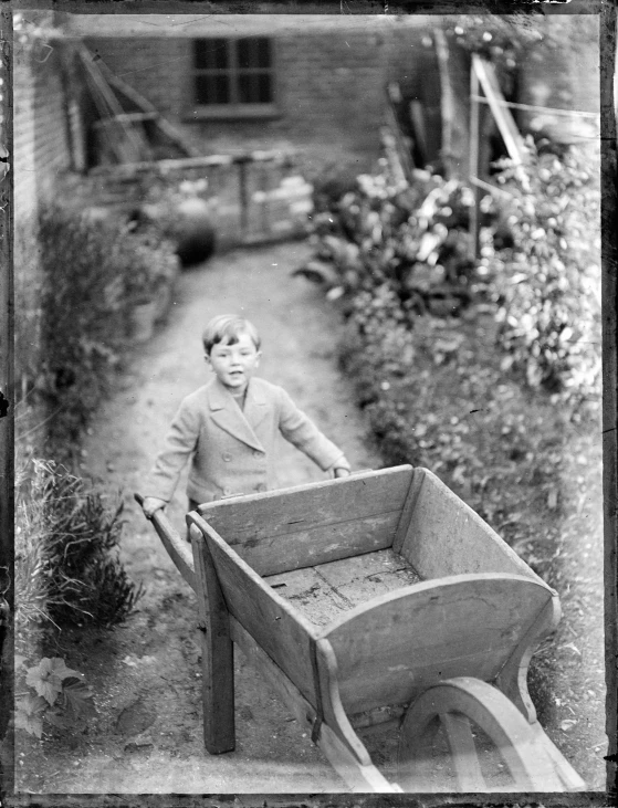 a black and white image of a  hing a wheelbarrow