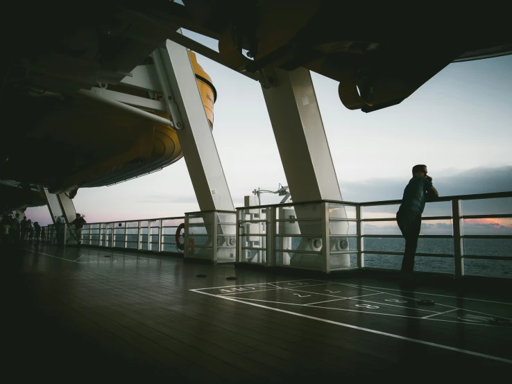 a person looking at the water while on a ship