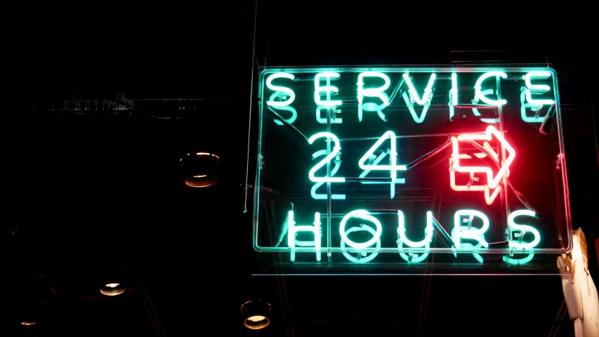 a street sign with a neon message on it