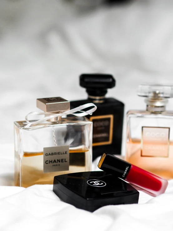 three perfume bottles sitting next to each other on a table