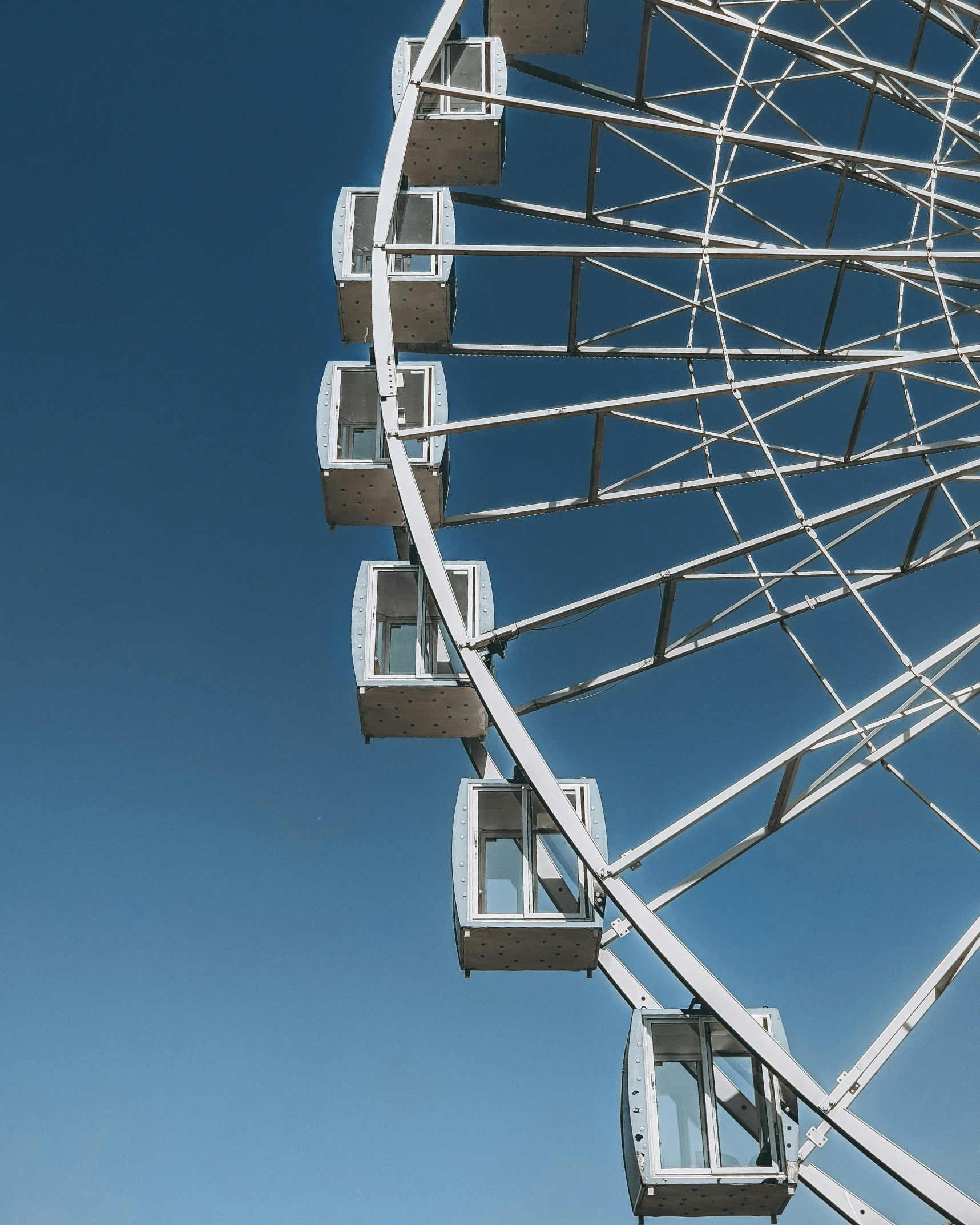 a large white ferris wheel against a blue sky