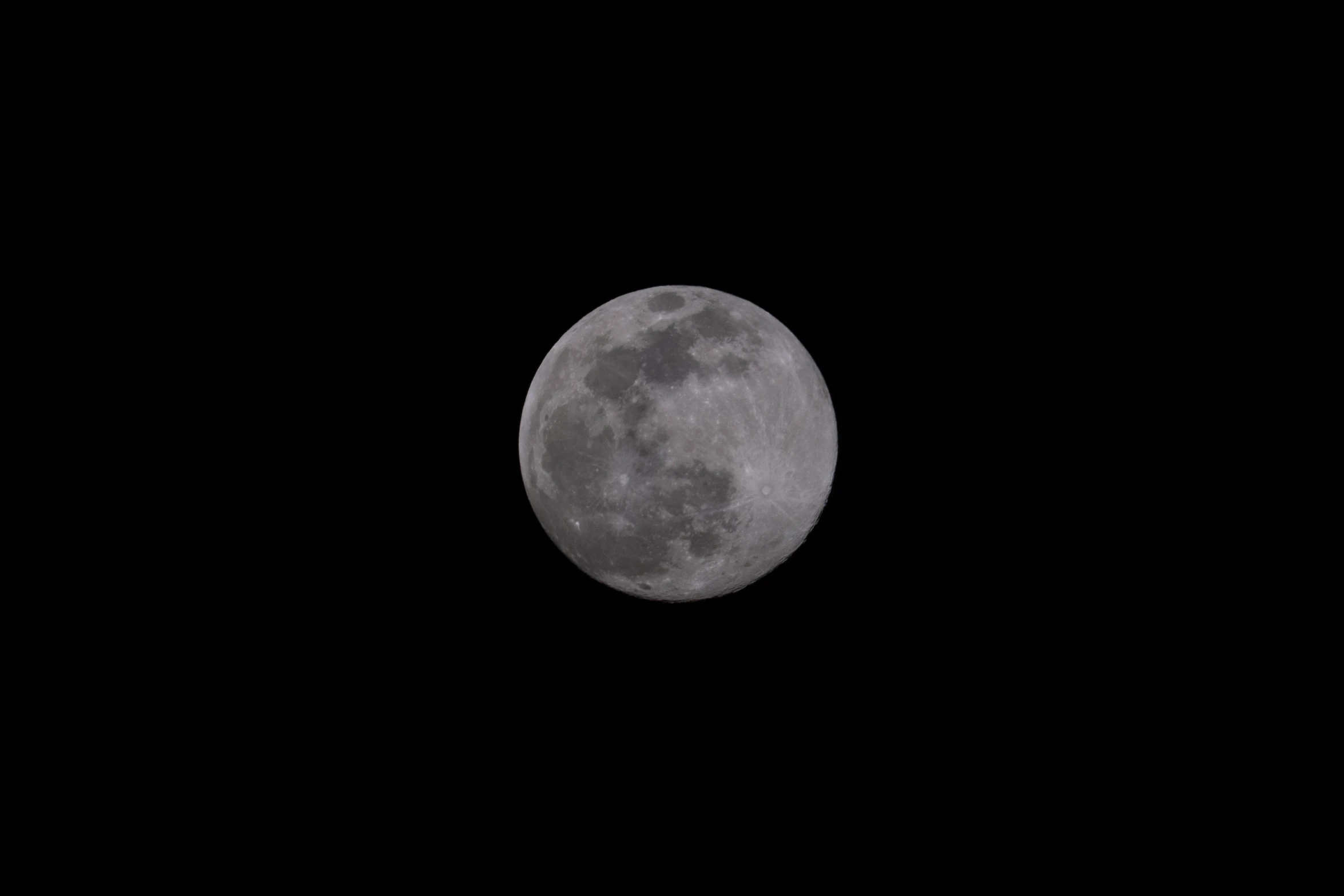 the moon seen through a telescope lens