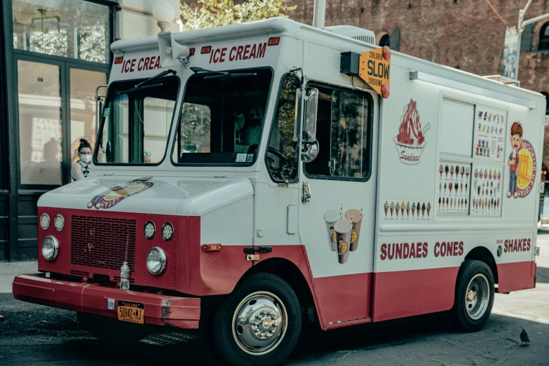 a white and red food truck parked on the street