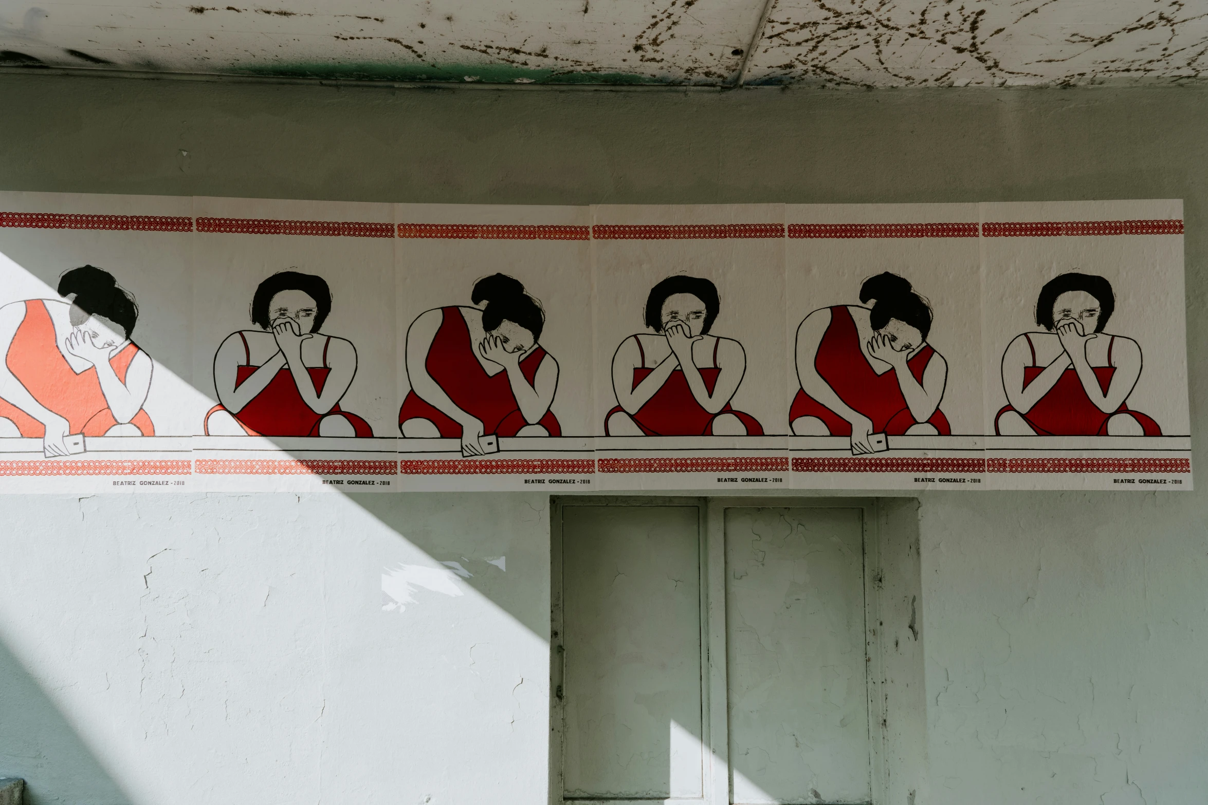 a street sign in thailand indicating there is a line of women in red skirts