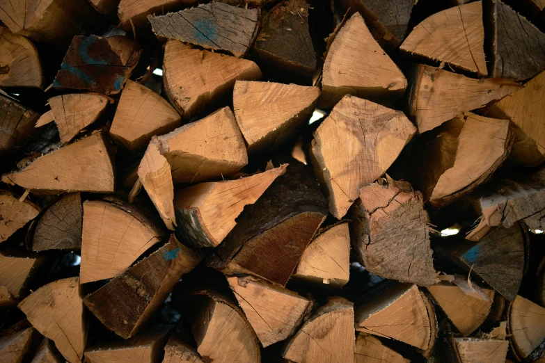 a pile of cut wood that is brown