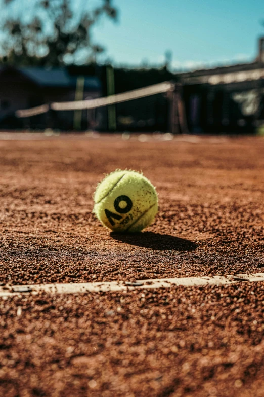 a closeup s of a tennis ball on the court