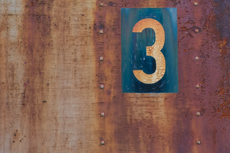 an image of number three on rusty metal