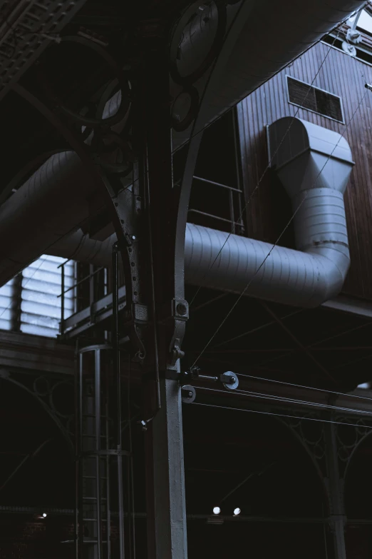 a large pipe in a building with lots of pipes on the side