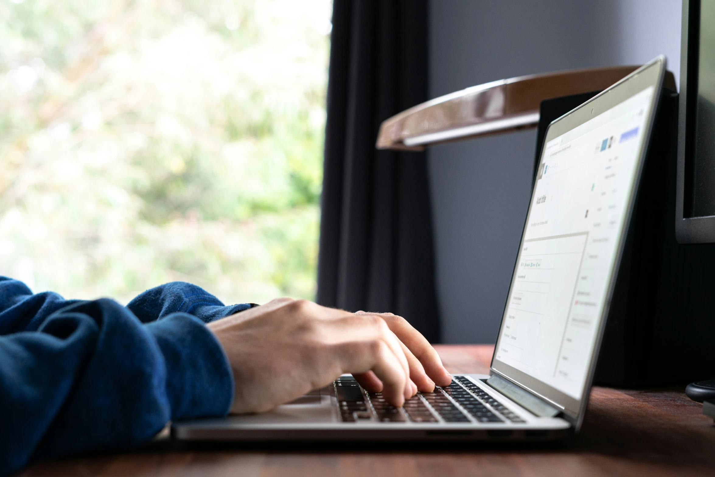 a woman using her laptop computer at her desk