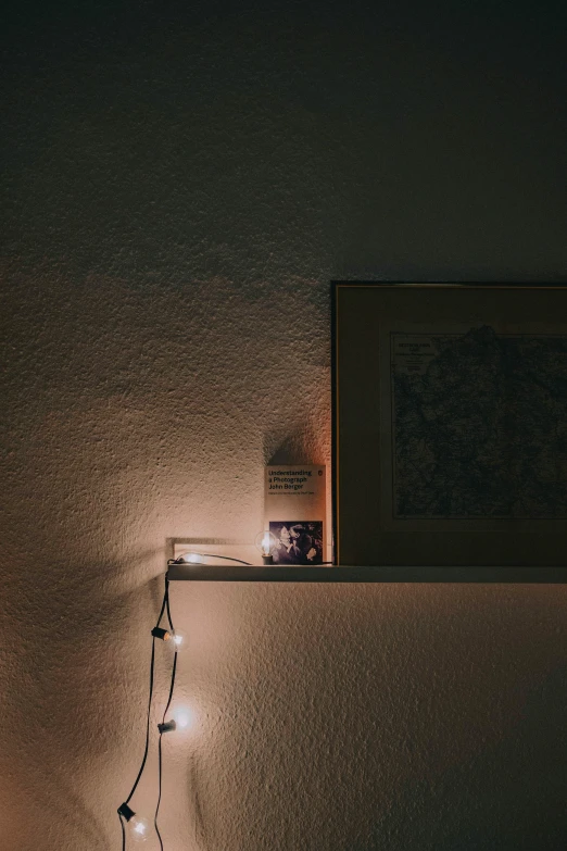 a light on top of a table next to an open book