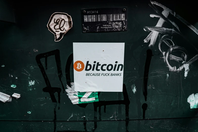 the name bitcoin is placed on the back of a black wall