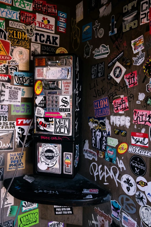 a large amount of stickers and decals on a wall