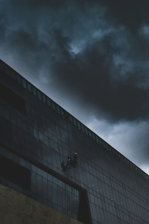 dark clouds cover the top of a building on a cloudy day