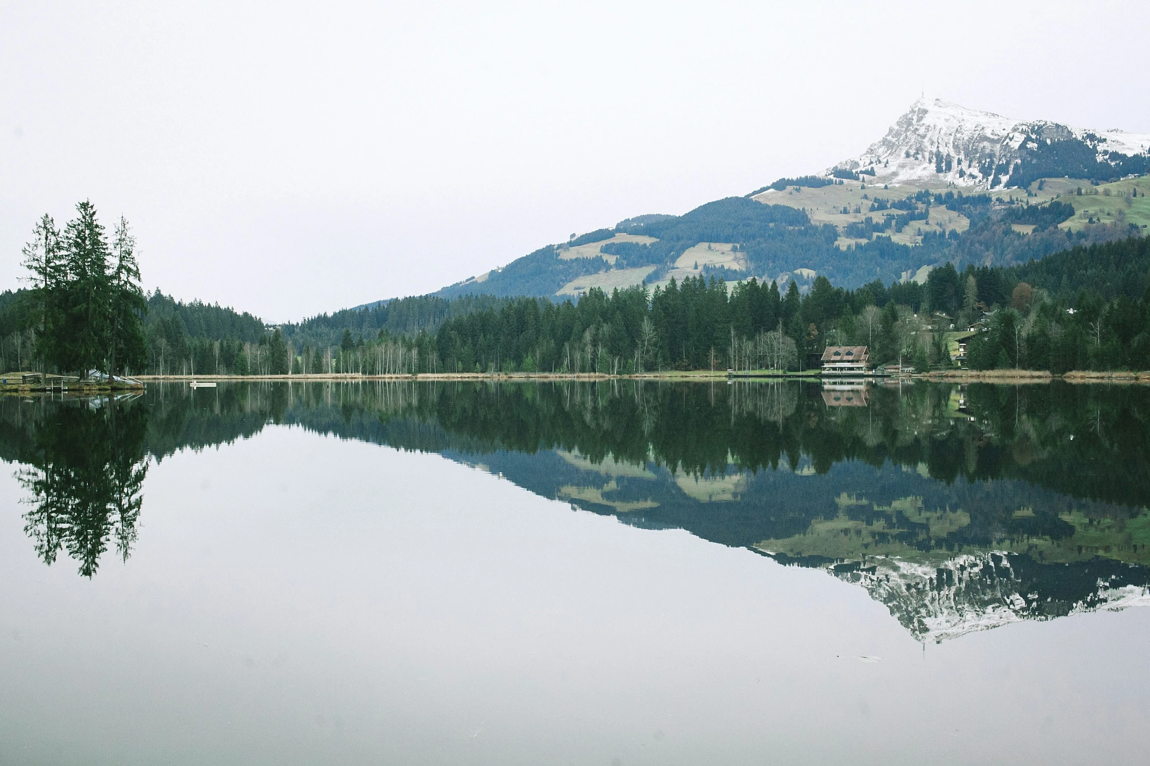 the mountains reflect in a calm lake