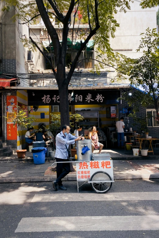 a man hing a shopping cart down a street