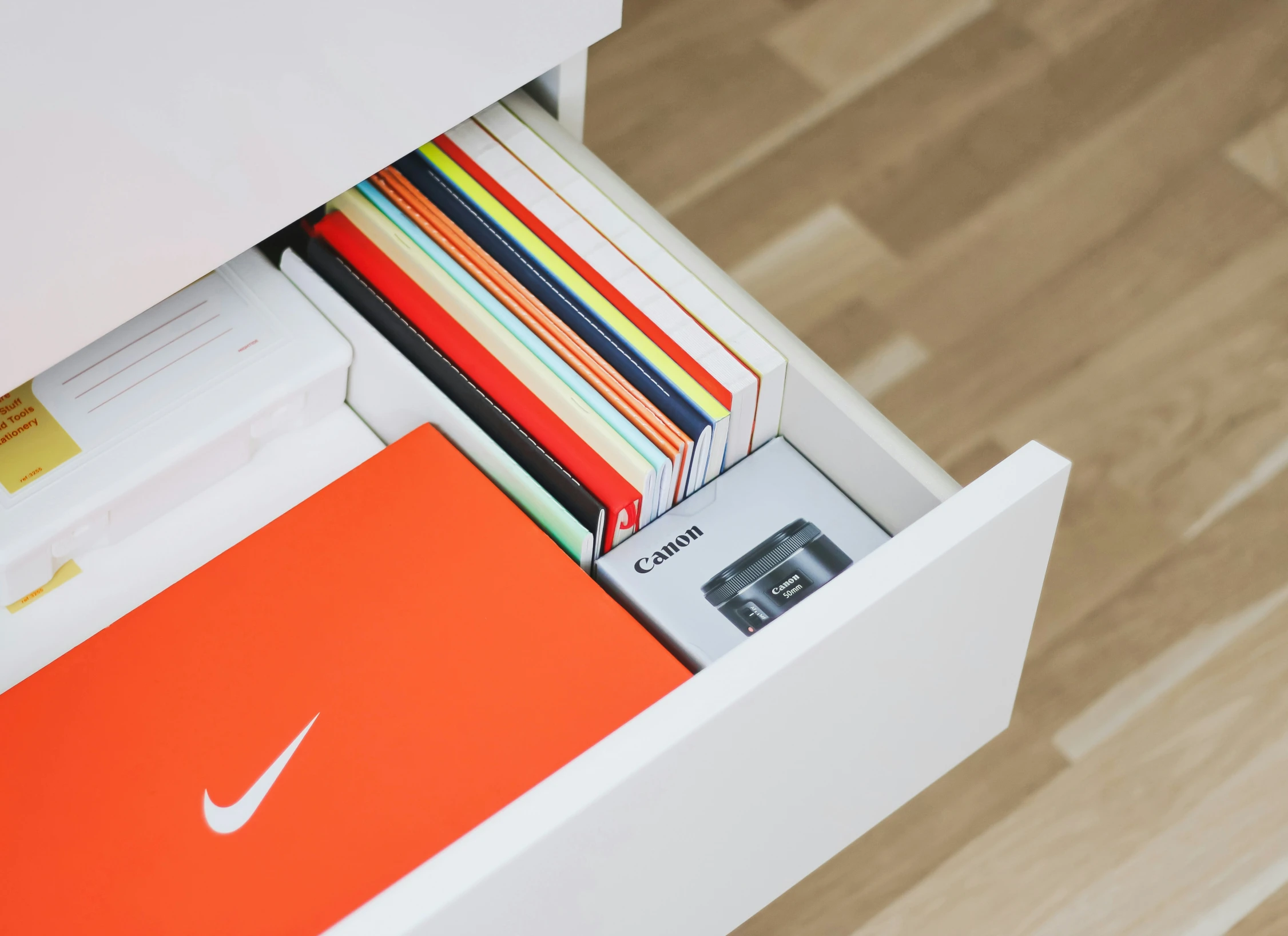 a box filled with lots of books on top of a wooden floor