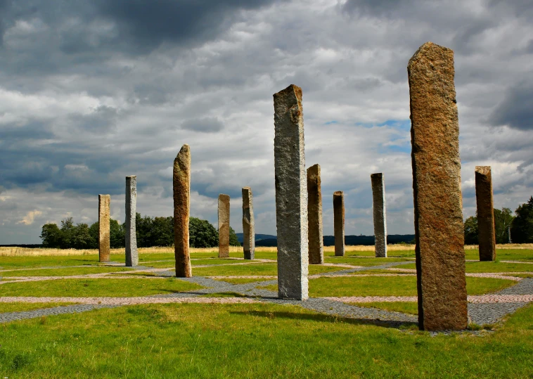 an ancient city with large stones and green grass