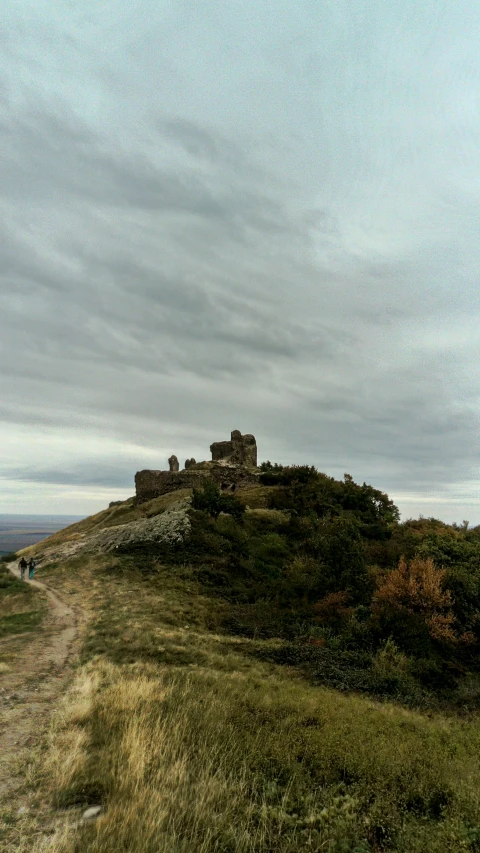 a road going up a hill towards a castle