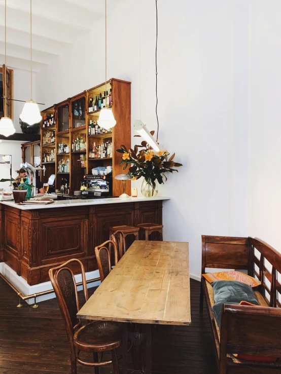 there is a wooden table sitting near a bar