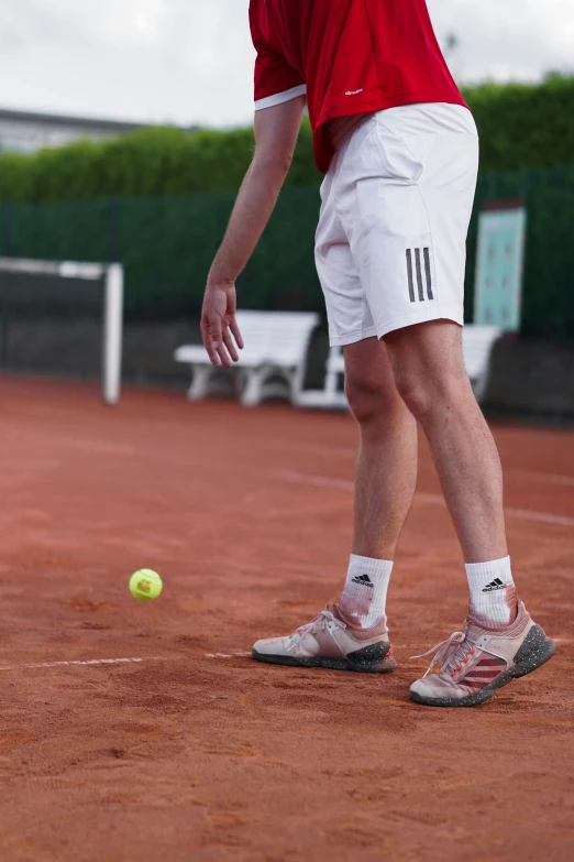 the man in white shorts is hitting the ball with his tennis racket