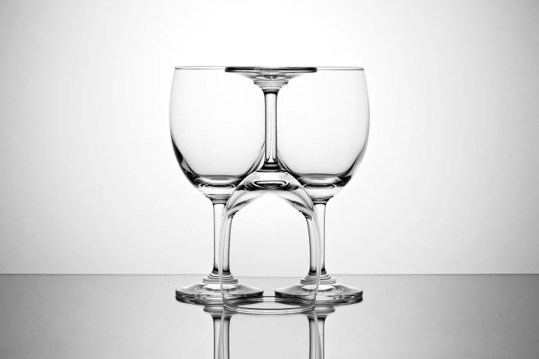 three glasses are stacked side by side in a black and white po